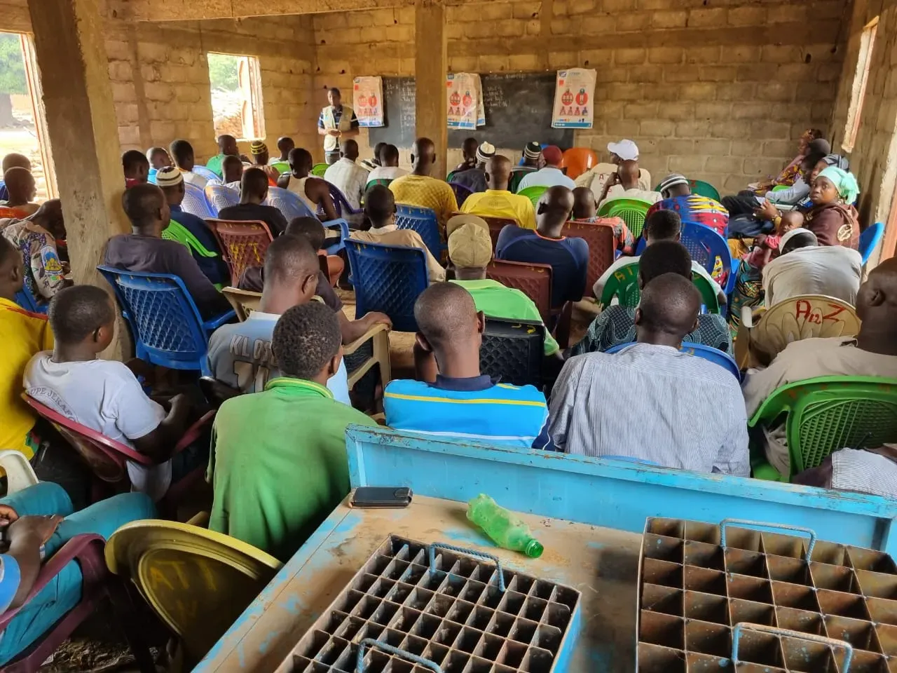 A group of people seated at an indoor community meeting.